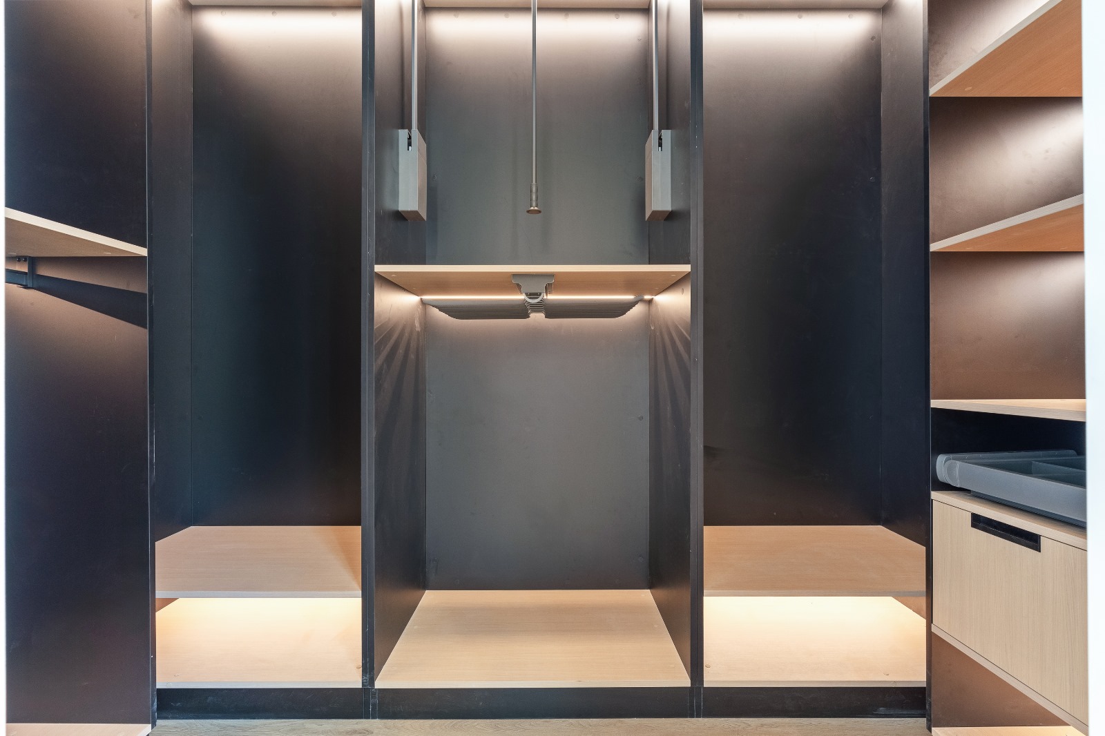 Custom wardrobe closet organizer with shelving and drawers in a Winnipeg home